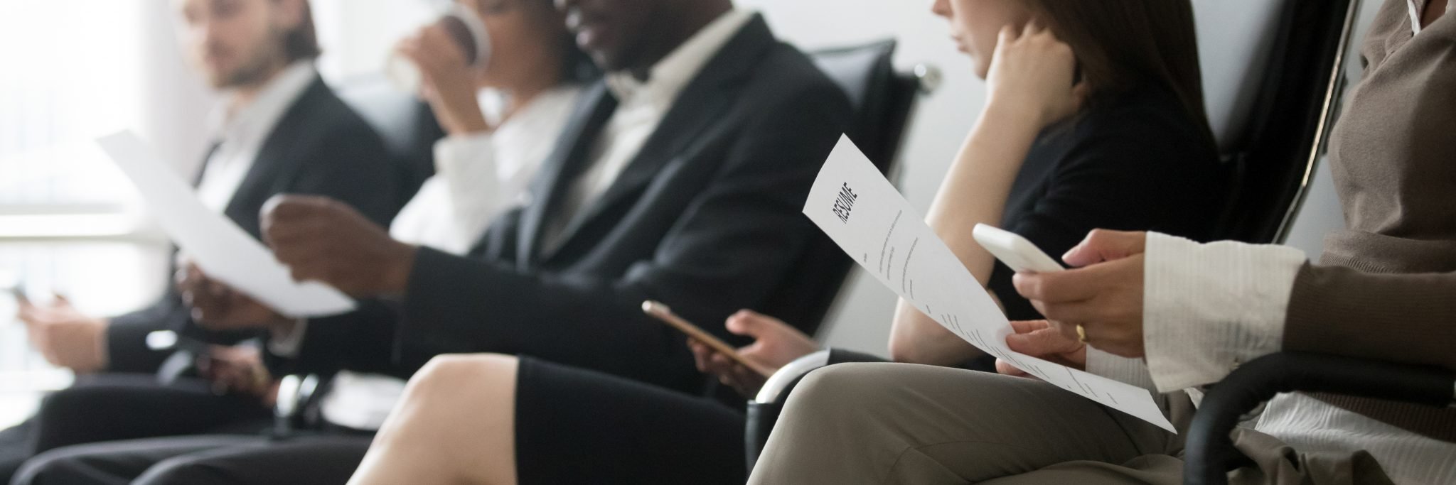 Side horizontal photo multiracial people sitting in queue waiting interview